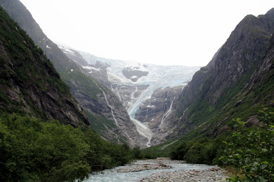 Kjenndalsbreen glacier tongue and waterfalls above a green valley near Loen in Western Norway