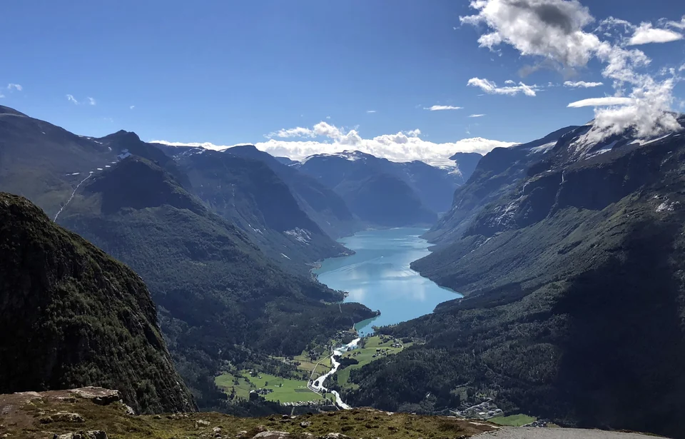 Long green-blue Lovatnet lake winding between steep mountains near Loen, seen from Mount Hoven in Norway