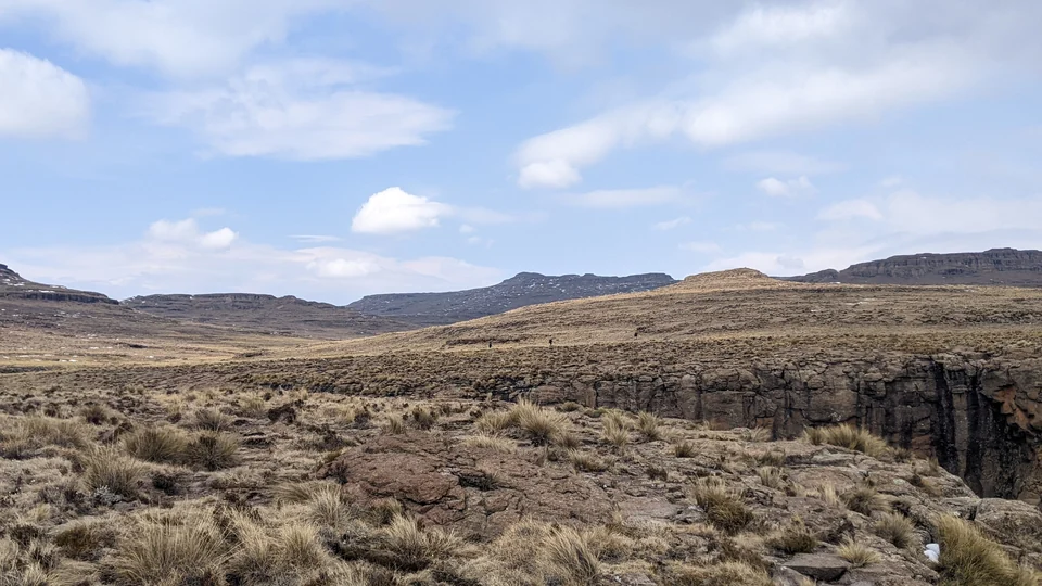 Grassy plateau and cliff edge near the chain ladders on the Mont-aux-Sources plateau, Drakensberg