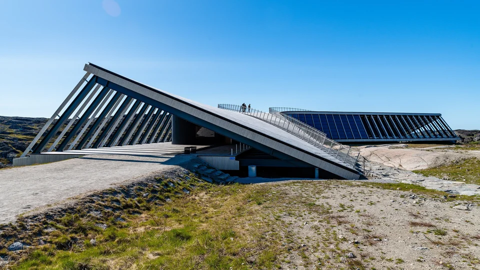 Curved timber Icefjord Centre building on rocky tundra above the Ilulissat Icefjord in Greenland