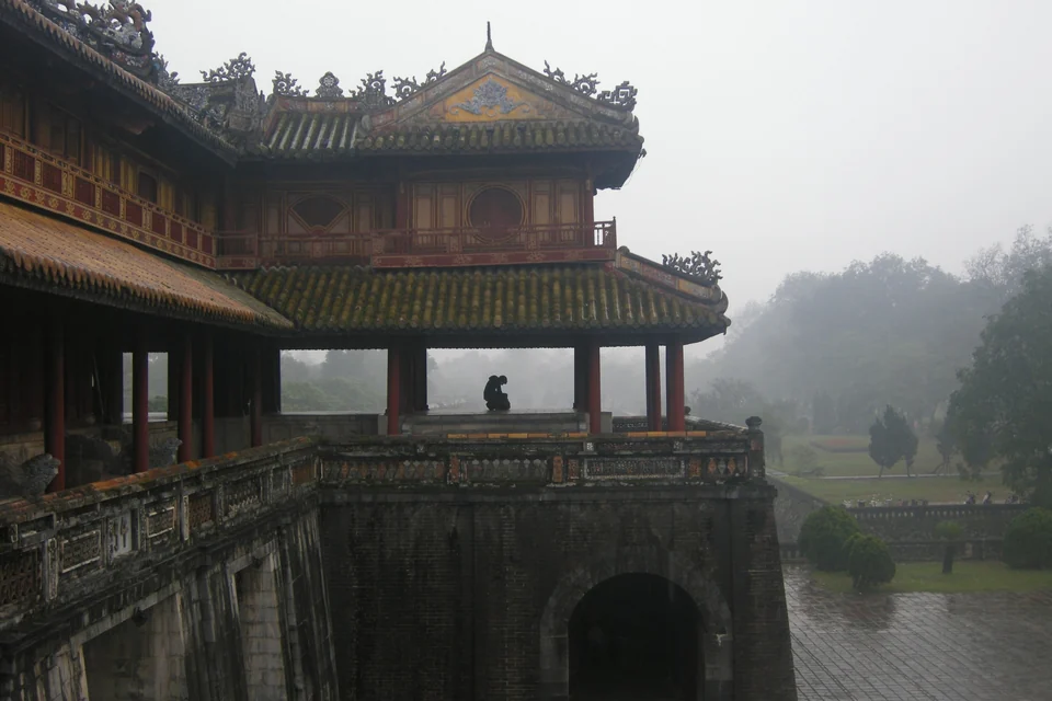 Ornate pavilion roof of the Meridian Gate at the Imperial City of Hue on a misty, rainy day