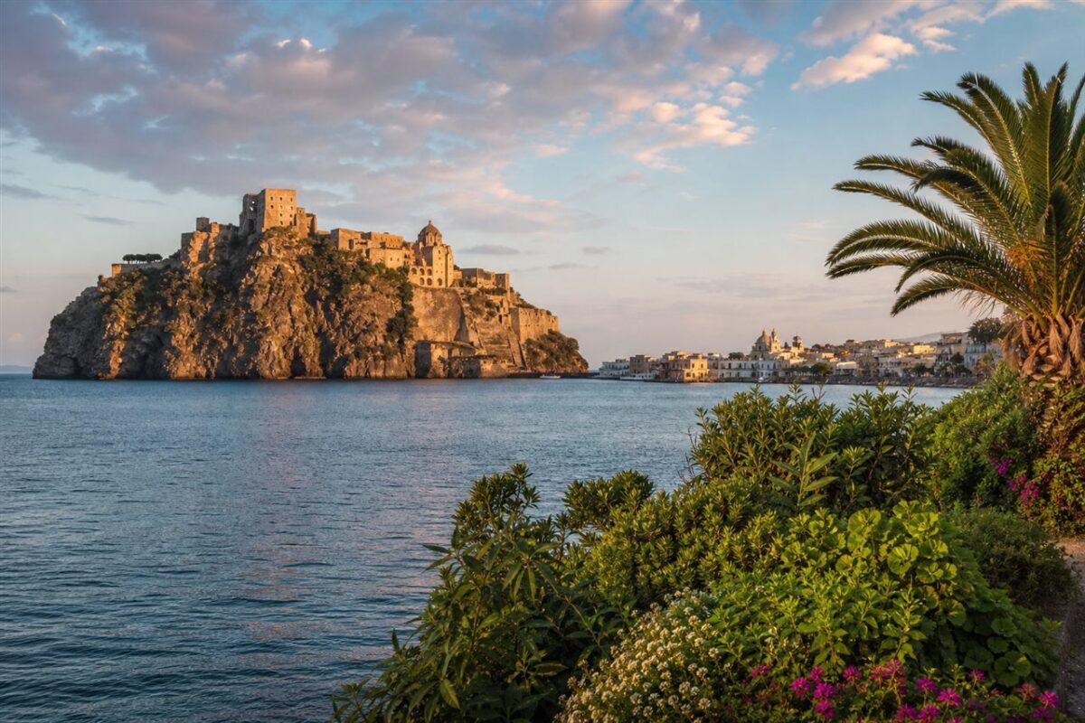 Aragonese Castle and coastal village on Ischia island Italy at sunset