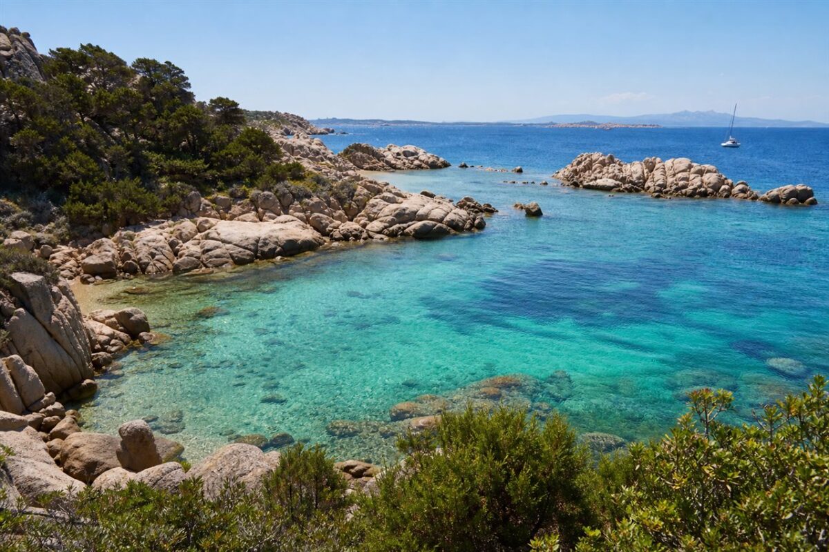 Clear turquoise cove surrounded by granite rocks in Sardinia Italy