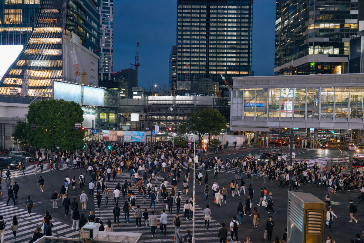 Shibuya Crossing in Tokyo during blue hour with pedestrians crossing